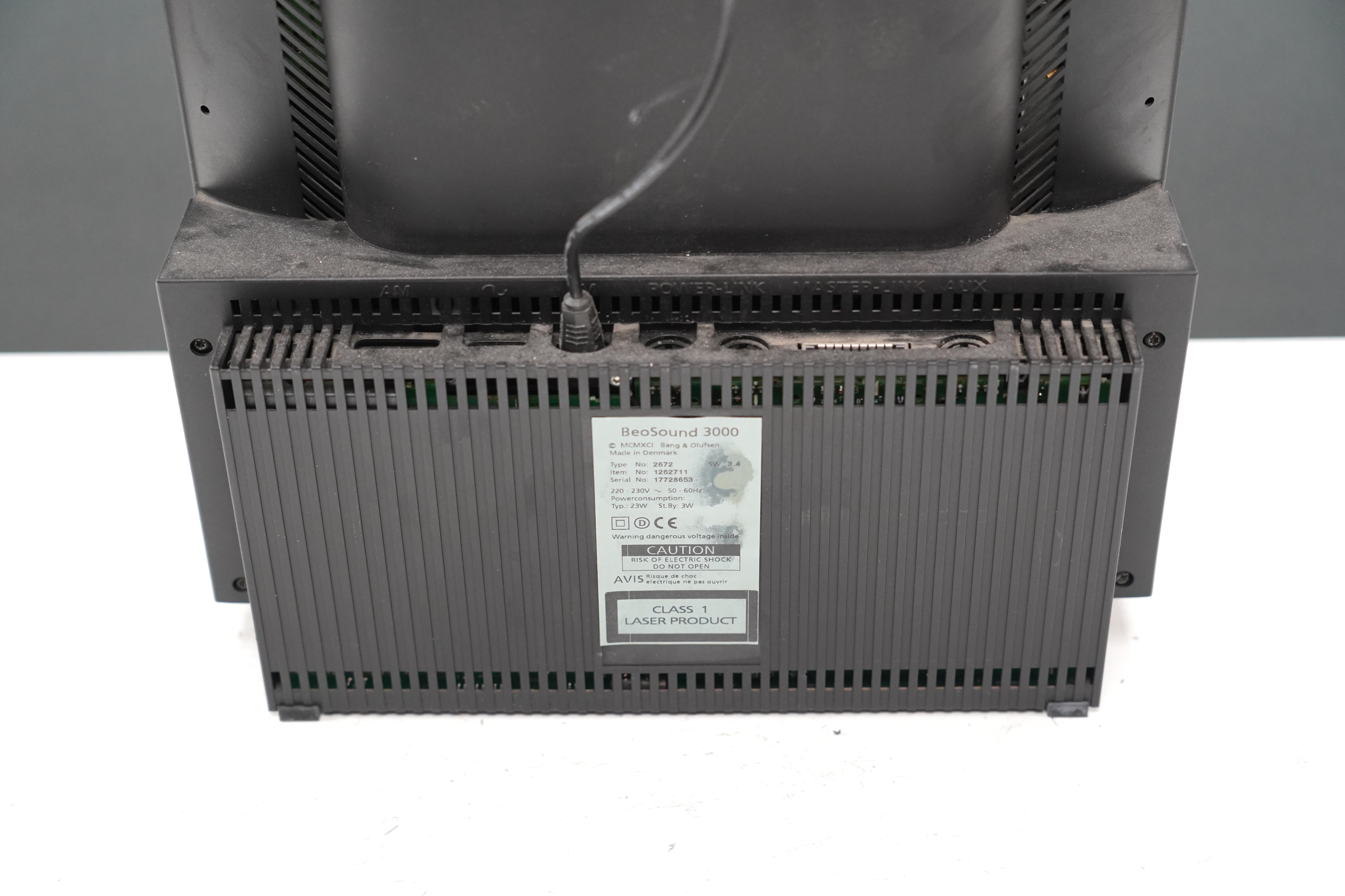 A Bang & Olufsen BeoSound 3000 CD player and music system, 37cm high, with instruction booklet, cables and remote control